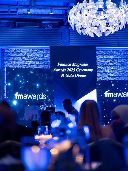 An abstract blue sculptural trophy on a black base reading 'National Broker of the Year' against a purple-lit background.